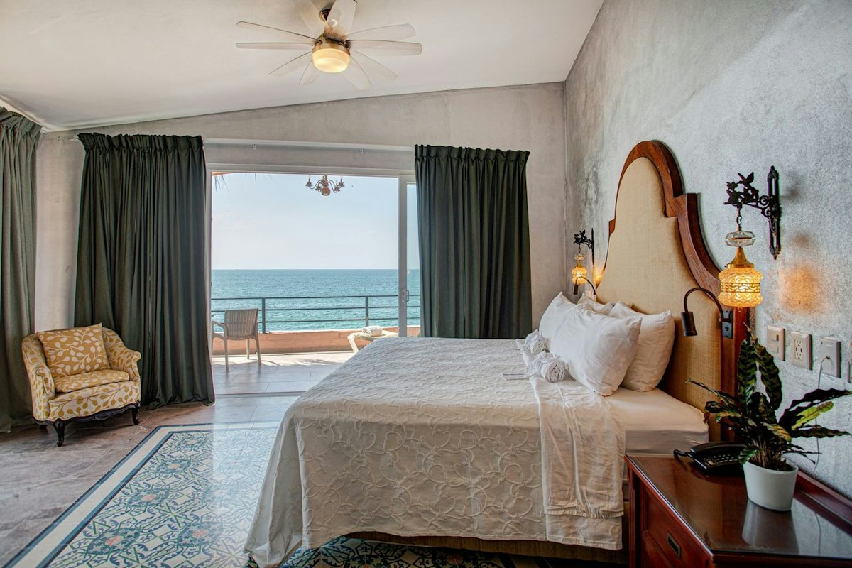 A Quinta Maria Cortez guest room opening to a private ocean-view terrace